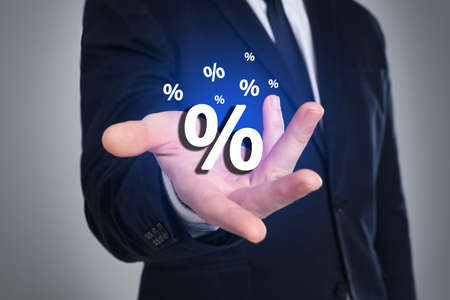 Man showing virtual percent sign on light gray background, closeup. discount conceptの写真素材