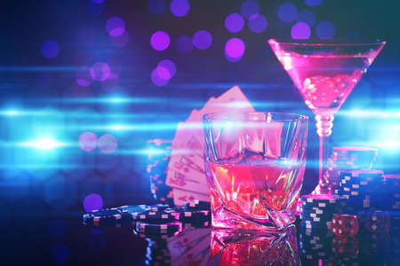 Alcohol drinks, dice, playing cards and casino chips on table against blurred lights. Straight poker combinationの写真素材