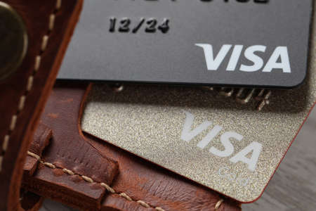 MYKOLAIV, UKRAINE - FEBRUARY 22, 2022: Wallet with Visa credit cards on table, closeup