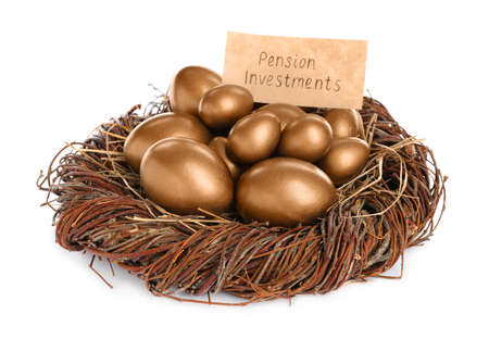 Many golden eggs and card with phrase Pension Investments in nest on white backgroundの写真素材