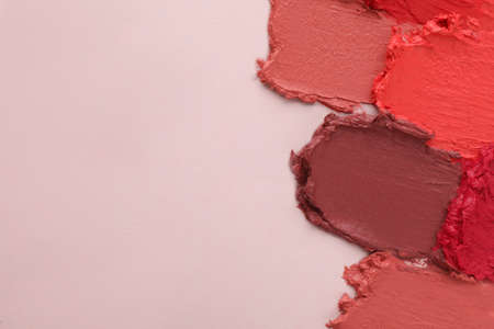 Smears of different beautiful lipsticks on light background, top view. Space for textの写真素材