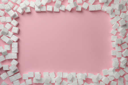 Frame made of  cubes on pink background, flat lay. Space for textの写真素材