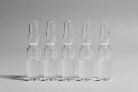 Pharmaceutical ampoules with medication on light gray backgroundの写真素材
