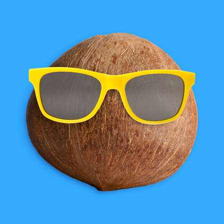 Funny coconut with sunglasses on turquoise background. summer partyの写真素材