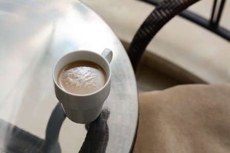 Ceramic cup of aromatic coffee on glass table outdoors, above view. good morningの写真素材