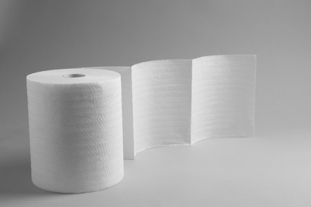 Roll of white paper towels on gray background. Space for textの写真素材