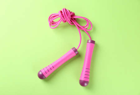 Skipping rope on light green background, top view. sports equipmentの写真素材