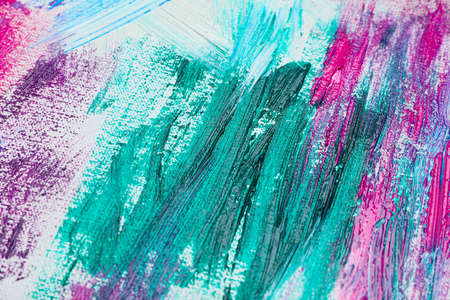 Strokes of colorful acrylic paints on white canvas, closeup