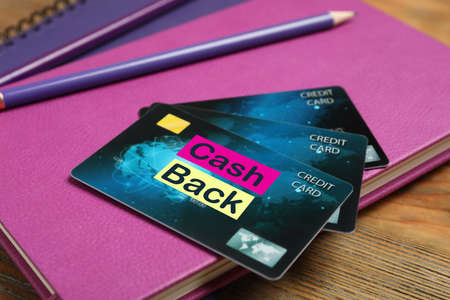 Notebooks, pencils and cashback credit cards on wooden table, closeupの写真素材