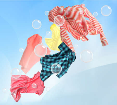 Washing powder bubbles and clothes flying in cloudy skyの写真素材