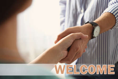 Welcome to team. Employee shaking hands with interns in office, closeupの写真素材