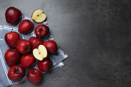 Fresh ripe red apples on gray table, flat lay. Space for textの写真素材
