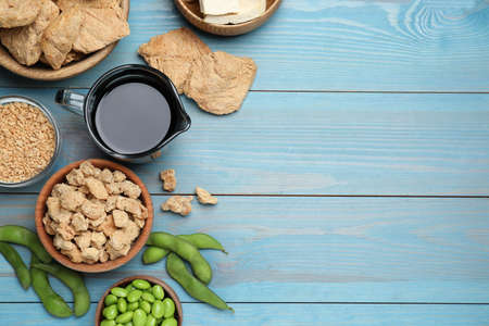 Different organic soy products on turquoise wooden table, flat lay. Space for textの写真素材
