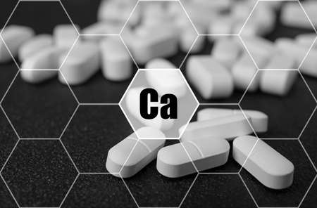 Calcium supplement pills on black background, closeupの写真素材