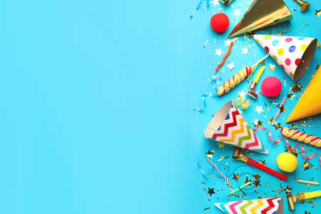 Beautiful flat lay composition with festive items on light blue background, space for text. Surprise party conceptの写真素材