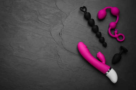 Sex toys on black background, flat lay. Space for textの写真素材