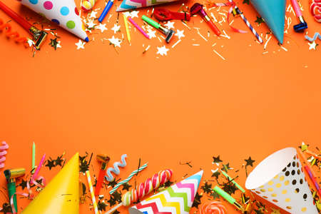 Beautiful flat lay composition with festive items on orange background, space for text. Surprise party conceptの写真素材