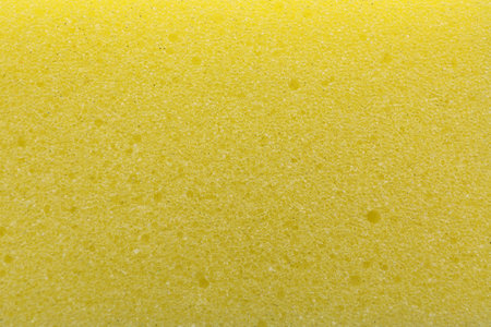 Yellow cleaning sponge as background, top viewの写真素材