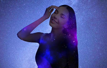Double exposure of beautiful woman and starry sky. Astrology concept