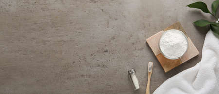 Flat lay composition with tooth powder on gray table, space for text. banner designの写真素材