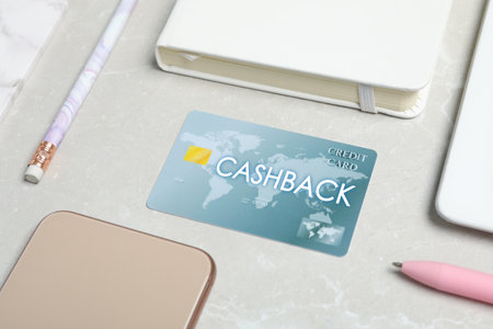 Composition with cashback credit card and stationery on light gray marble backgroundの写真素材