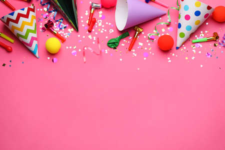 Beautiful flat lay composition with festive items on pink background, space for text. Surprise party...