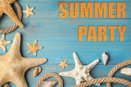 Beautiful sea stars, shells and rope on blue wooden background, flat lay. summer party