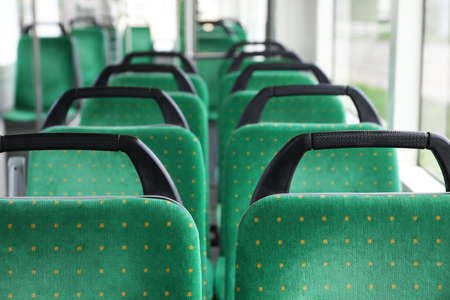 Rows of comfortable green seats in public transportの写真素材