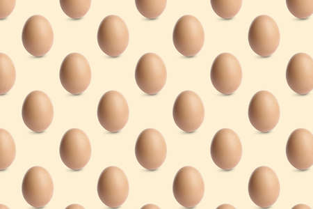 Group of chicken eggs on beige background. Seamless pattern design