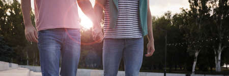 Couple walking outdoors on sunny day, closeup. banner design