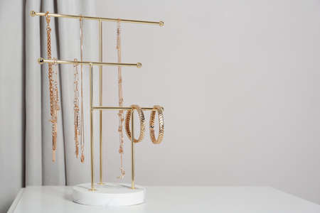 interior element. Holder with set of luxurious jewelry on white table. Space for textの写真素材