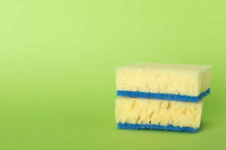 Sponges on green background. Space for text