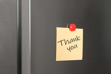 Note with phrase Thank You on refrigerator doorの写真素材