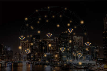 Picturesque view of the city with buildings at night and wi-fi symbolsの写真素材