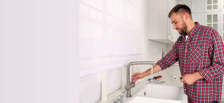 Plumber checking water flow from tap in , space for text. banner design