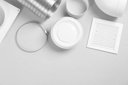Parts of home ventilation system on light gray background, flat lay. Space for textの写真素材
