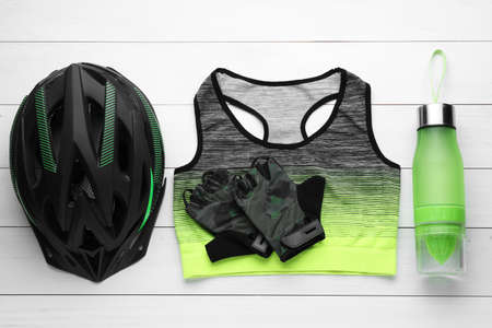 Flat lay composition with different cycling accessories on white wooden backgroundの写真素材