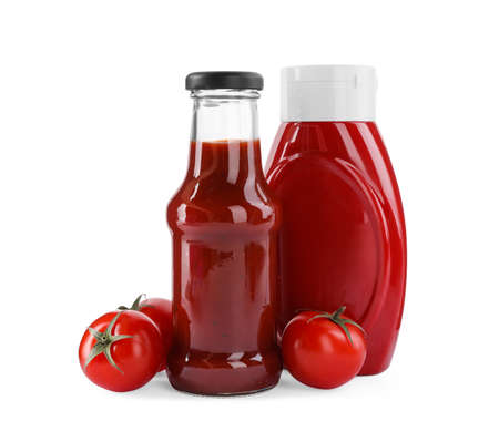 Different bottles of tasty ketchup and fresh tomatoes isolated on whiteの写真素材
