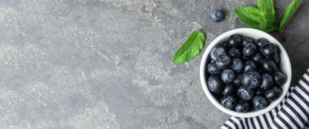 Tasty fresh blueberries on light gray table, flat lay with space for text. banner designの写真素材