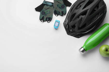 Flat lay composition with different cycling accessories on white background, space for textの写真素材