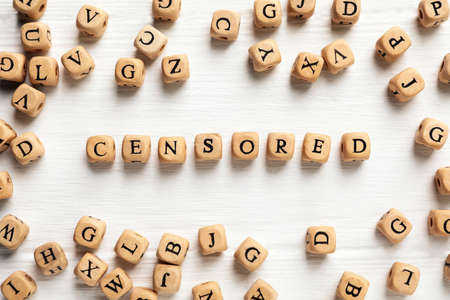 Wooden cubes with word Censored on white table, flat layの写真素材