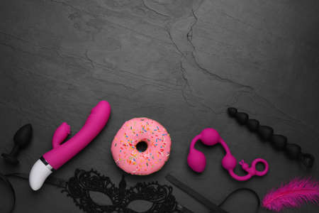 Flat lay composition with sex toys on black background. Space for textの写真素材