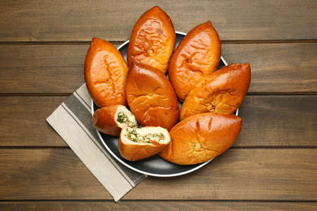 Delicious baked patties with eggs on wooden table, top viewの写真素材