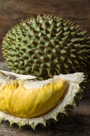 Fresh ripe durian fruits on wooden table, closeup