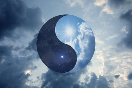 Ying Yang symbol against cloudy sky. Feng Shui philosophyの写真素材