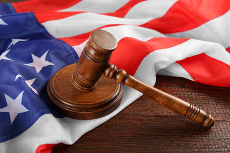 Judge's gavel and American flag on wooden tableの写真素材