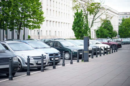Parking meter and cars on city street. modern deviceの写真素材