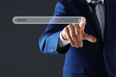 Businessman using search bar of website on virtual screen, closeupの写真素材