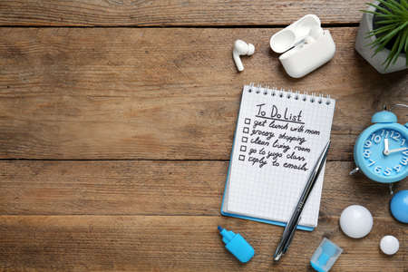 Flat lay composition with to do list on wooden table, space for text