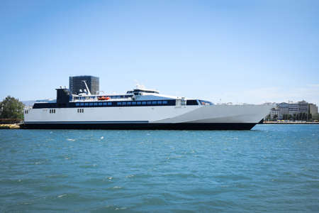 Modern ferry in seaport on sunny day